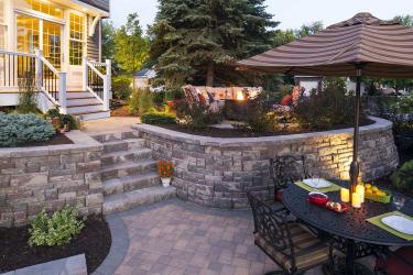 Modular block multi-level backyard retaining walls help manage this steeply sloping back yard
