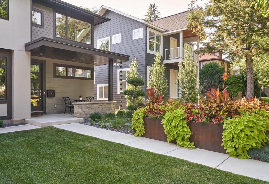 Modern home with corten steel planters and overflowing potato vine - Minneapolis, Minnesota. 