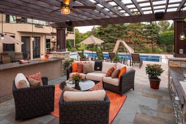 luxury outdoor living room with bluestone patio and ceiling fan