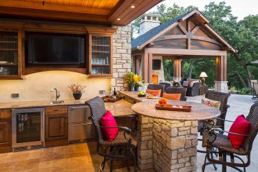 Outdoor Bar with TV, Beverage Cooler, and Sink. Pool house outdoor living room with fireplace and television