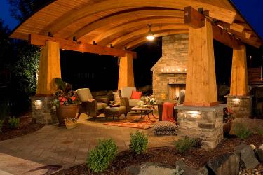 outdoor room with fireplace and aching ceiling