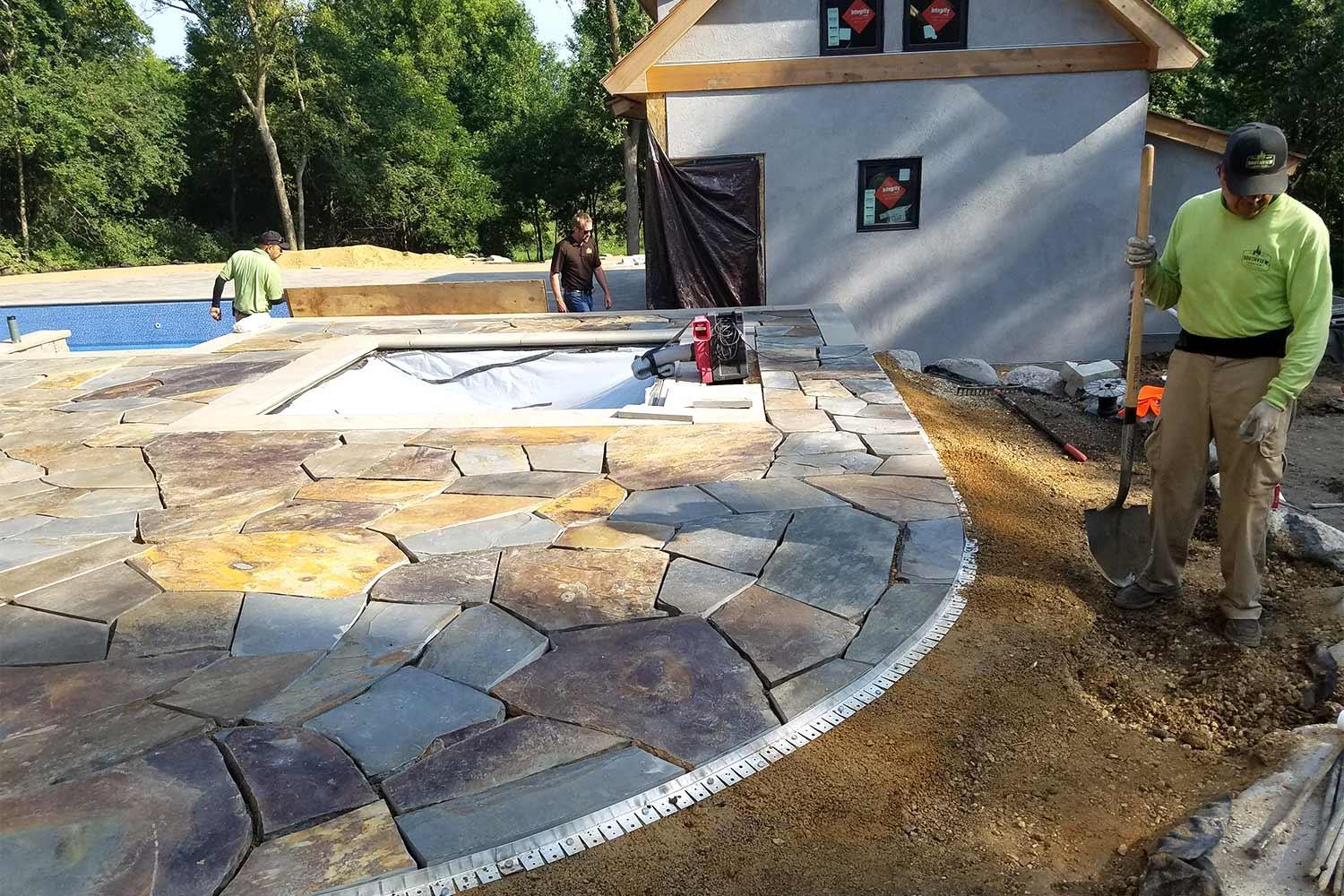 Southview Design's construction crew installing the natural stone patio.