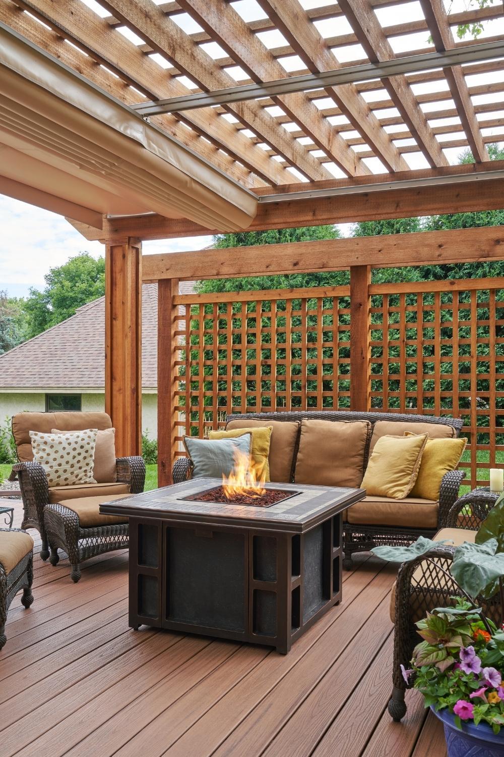 deck with living furniture, gas fire table, pergola shade is open