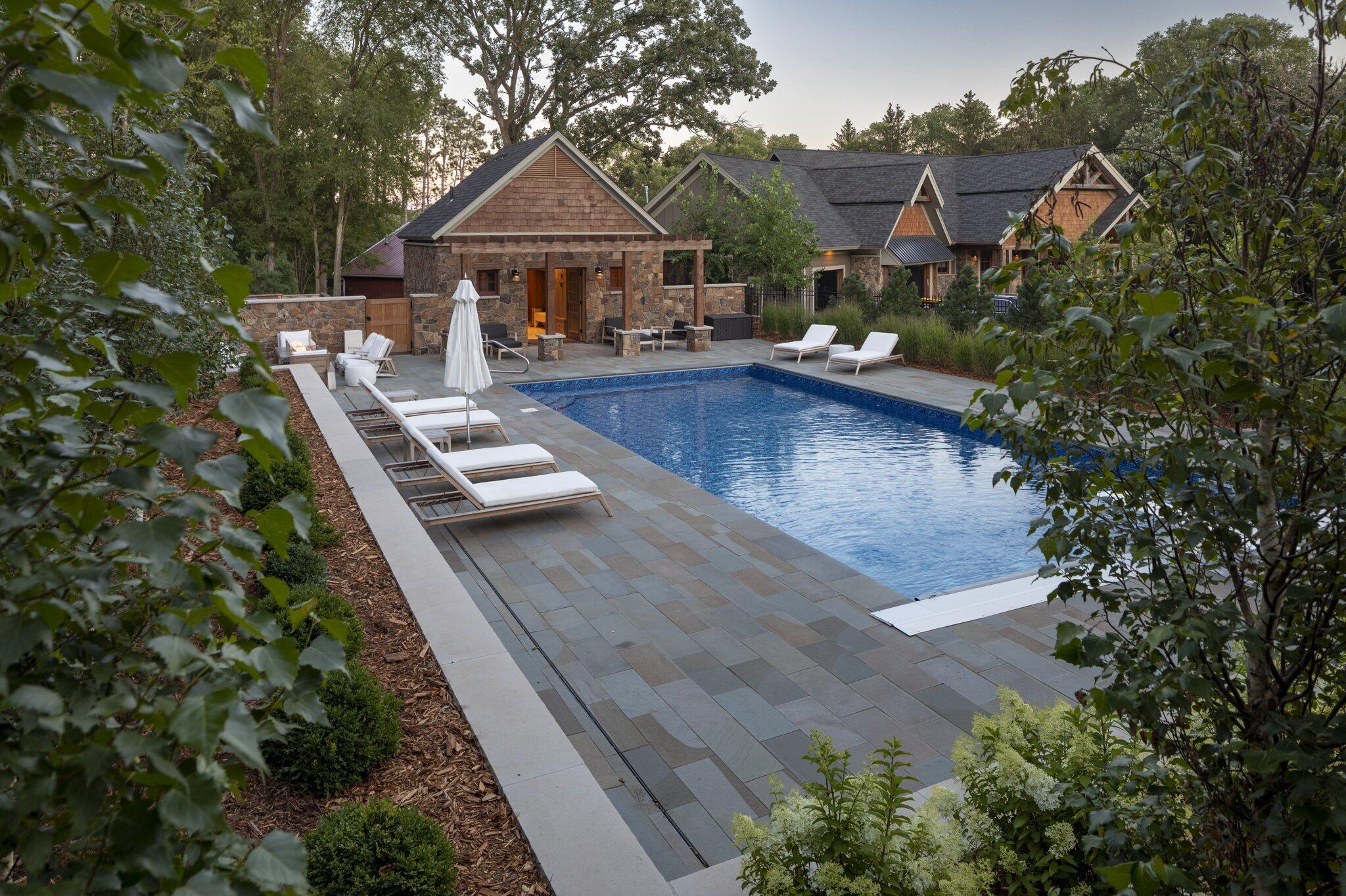 pool house and swimming pool with bluestone ad hydrangeas 