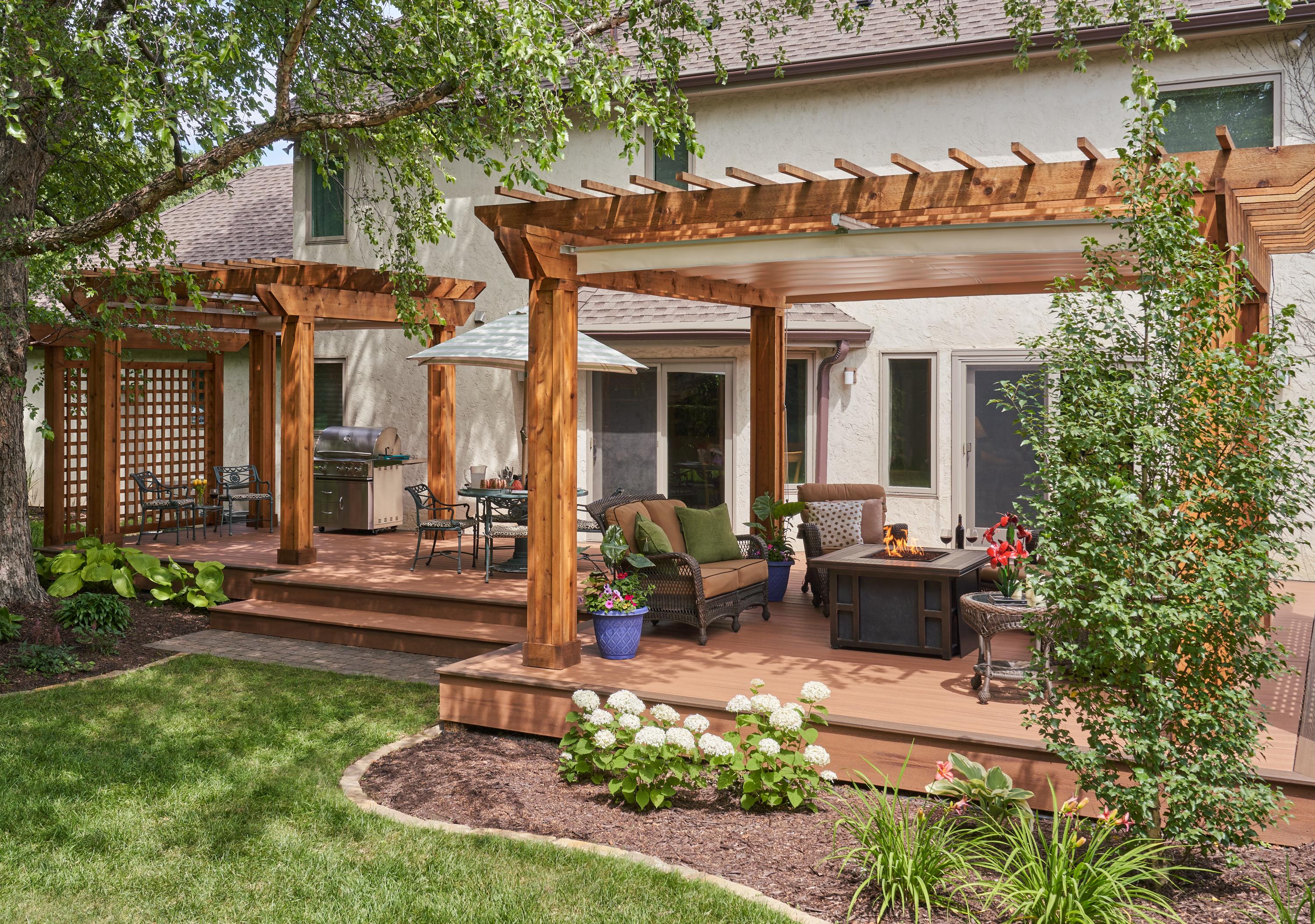 deck with a wood pergola and trellis, living furniture and fire table, grill