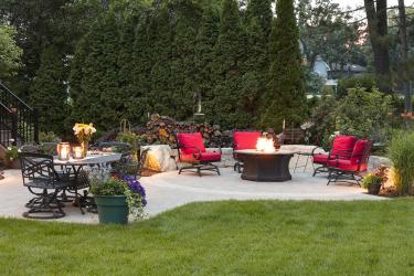 backyard patio for having people over with dining table and fire table